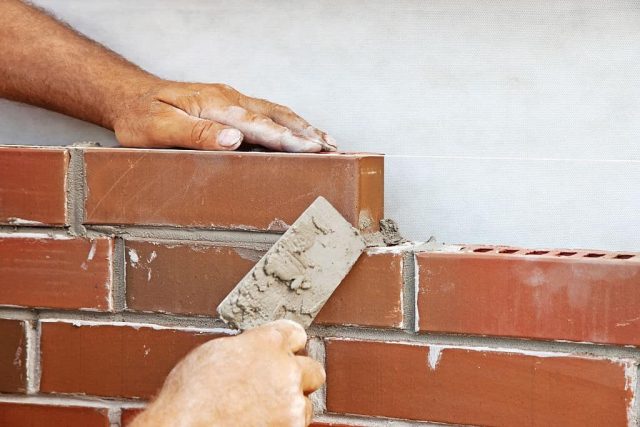 Masonry Contractor laying bricks